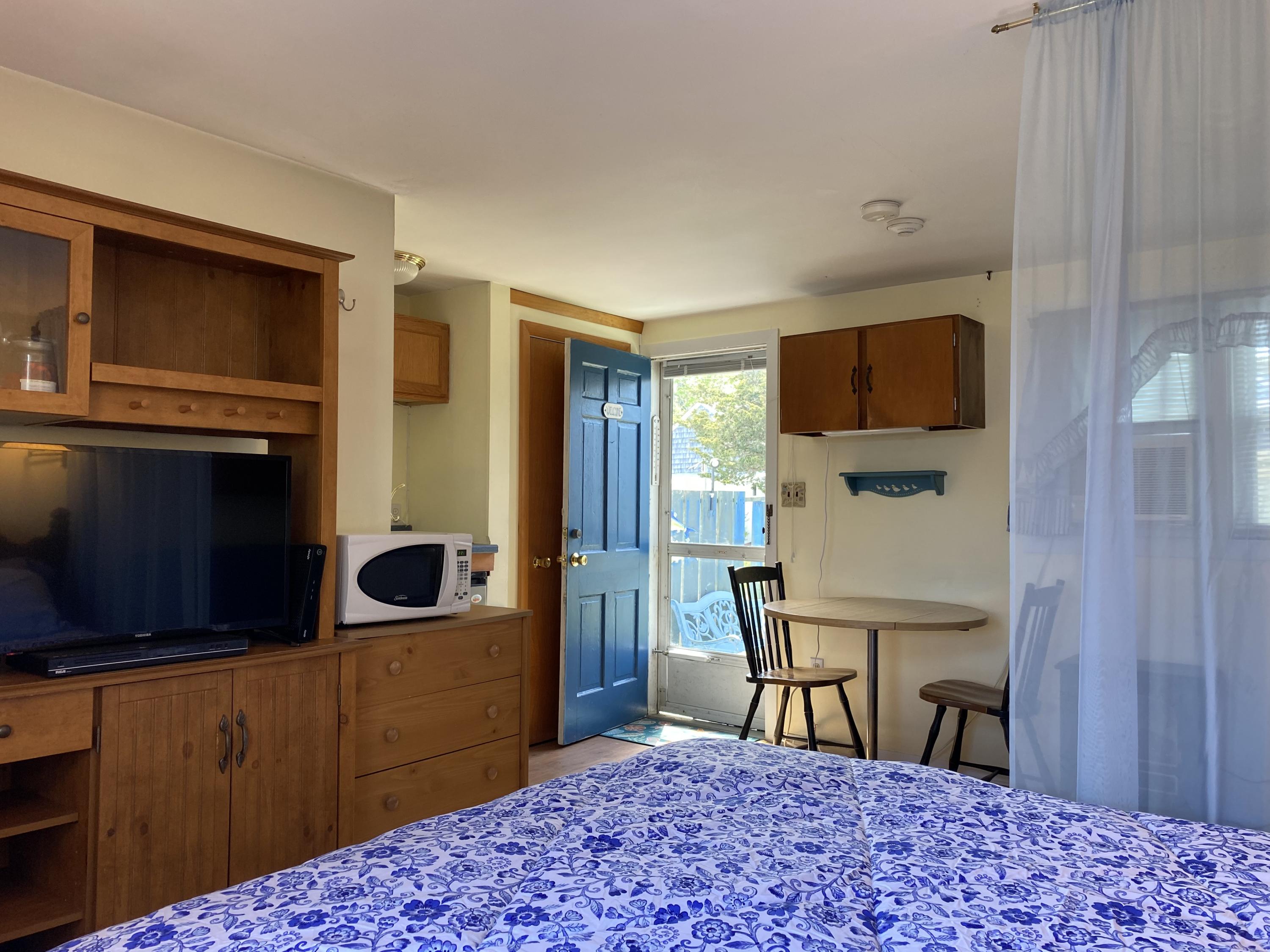 465 Lower County Road, Unit 3A Dennis Port, MA 02639 - Photo 6 of 33 a kitchen with a refrigerator and a wooden cabinets