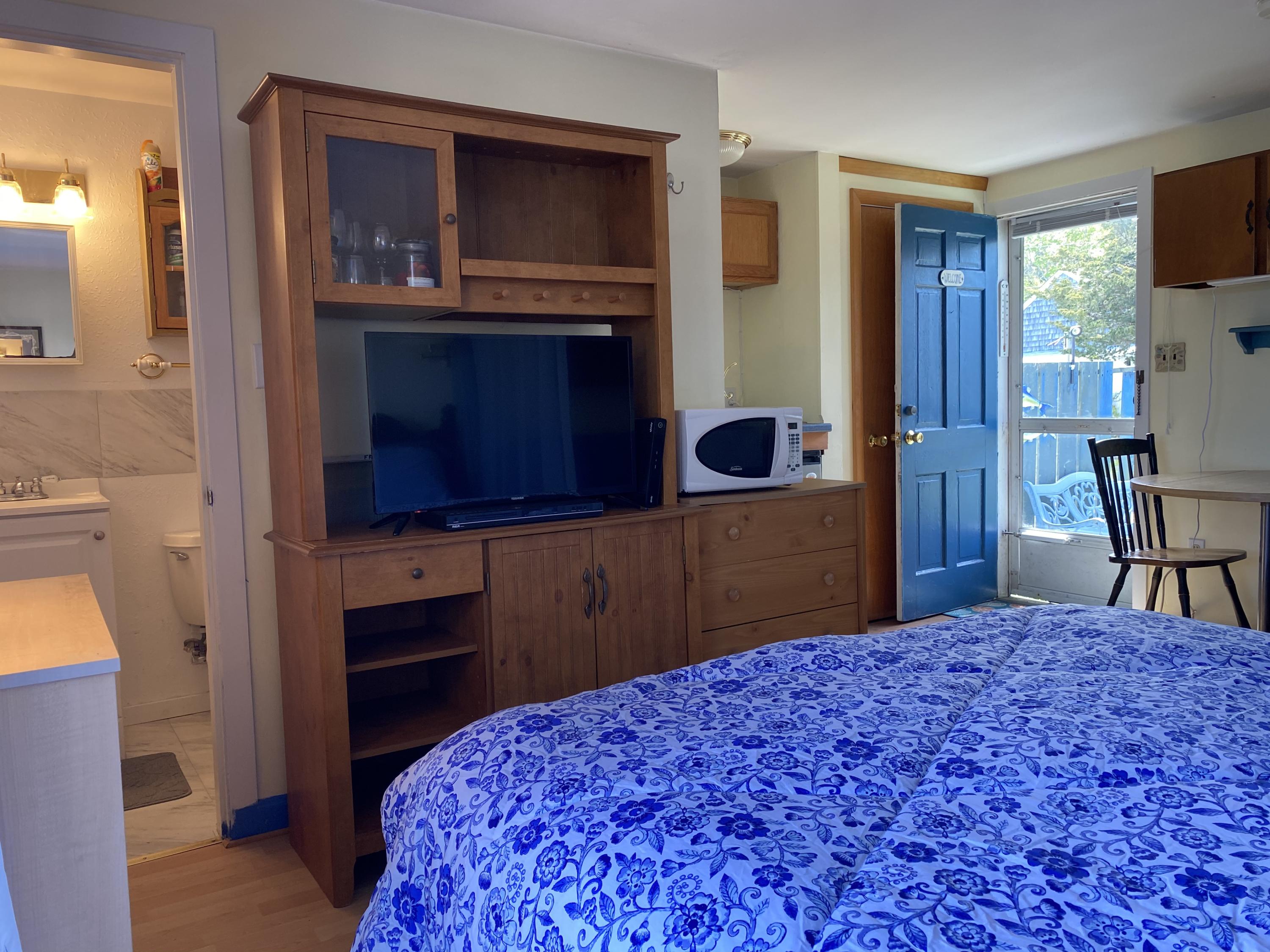 465 Lower County Road, Unit 3A Dennis Port, MA 02639 - Photo 8 of 33 a bedroom with a bed and a television in it