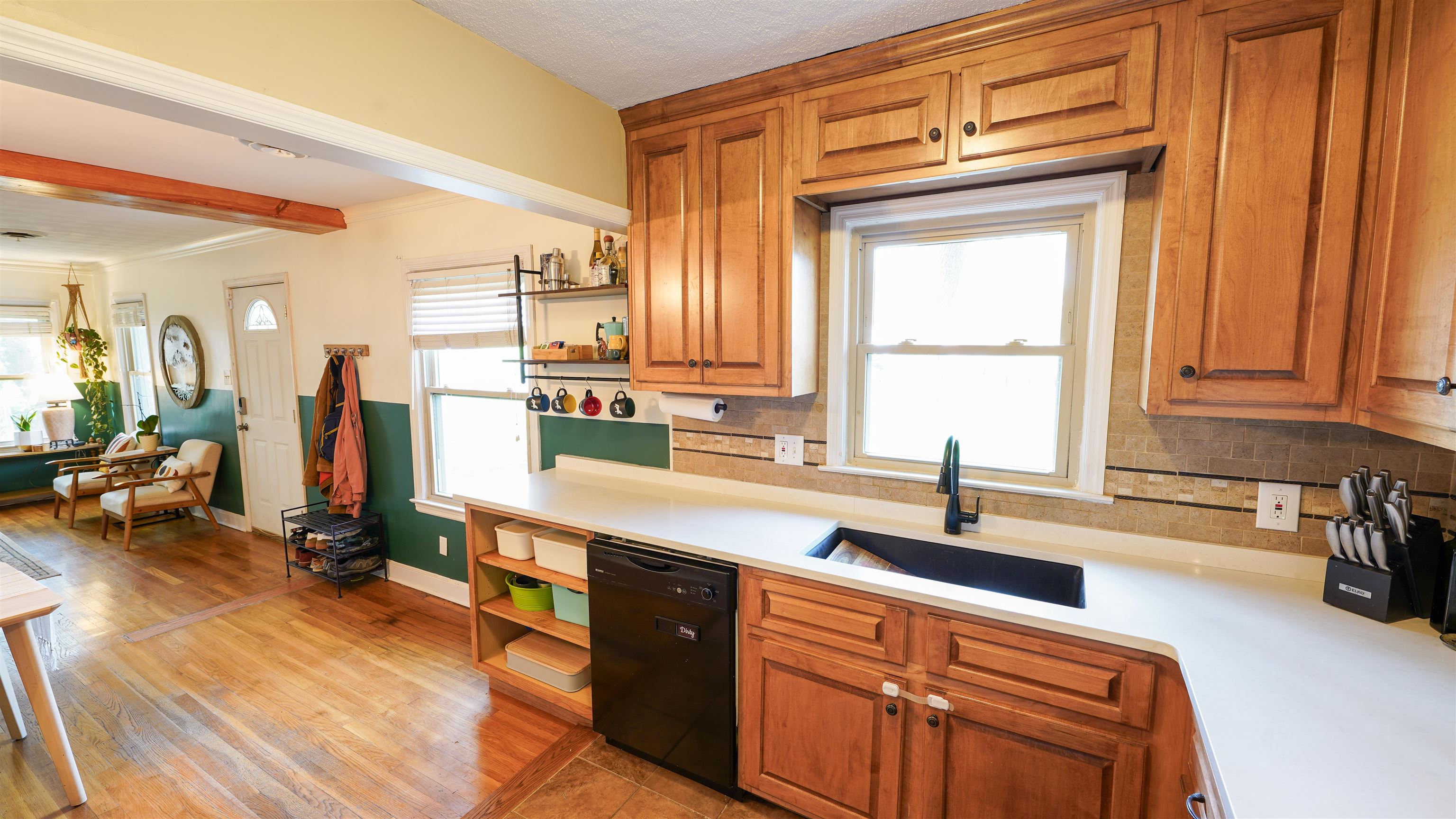 784 Vaughn Road Memphis, TN 38122 - Photo 9 of 28 a kitchen with stainless steel appliances granite countertop a sink dishwasher stove and wooden cabinets