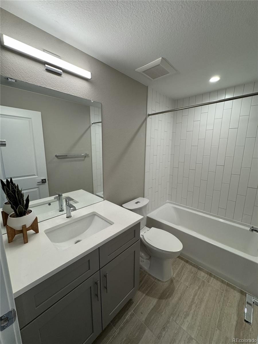 2660 South Delaware Street, Unit 9 Denver, CO 80223 - Photo 11 of 19 a bathroom with a double vanity sink toilet and shower