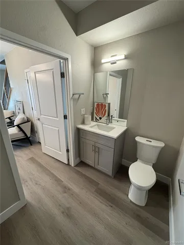 a bathroom with a toilet sink and a mirror