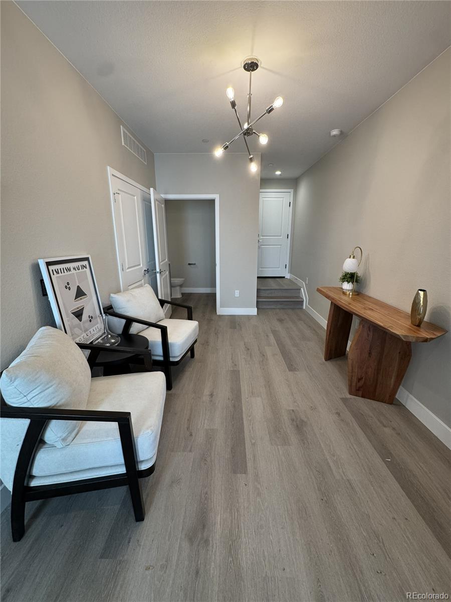 2660 South Delaware Street, Unit 9 Denver, CO 80223 - Photo 13 of 19 a living room with furniture and a wooden floor