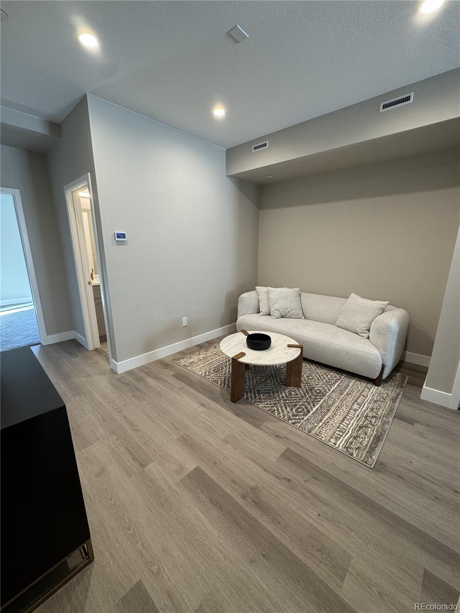 2660 South Delaware Street, Unit 9 Denver, CO 80223 - Photo 4 of 19 a living room with furniture and a rug