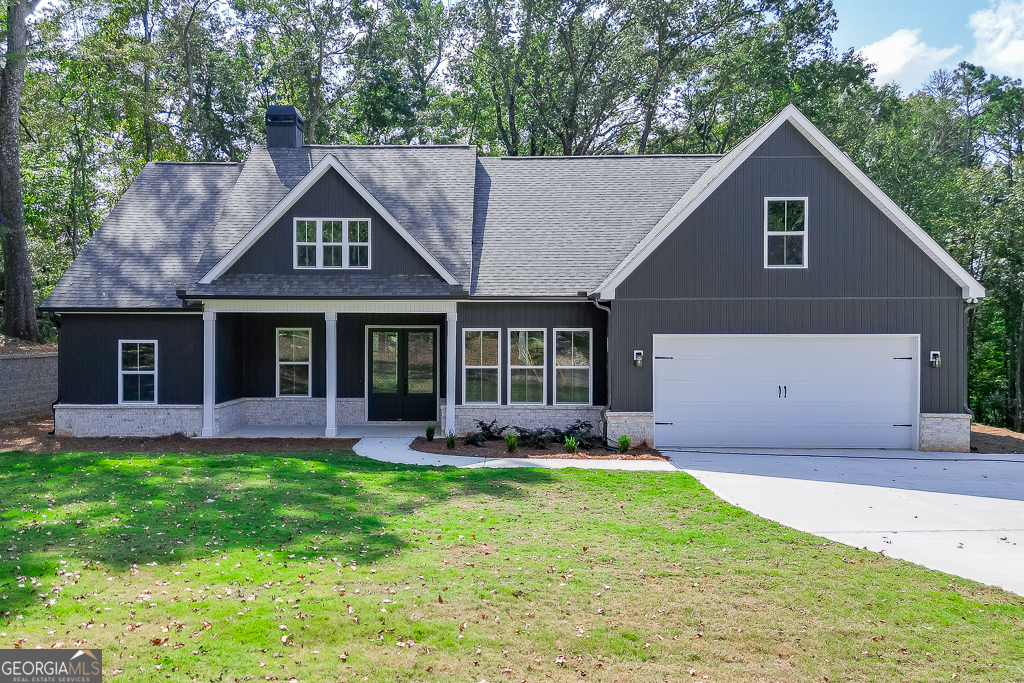 a front view of a house with a yard and porch
