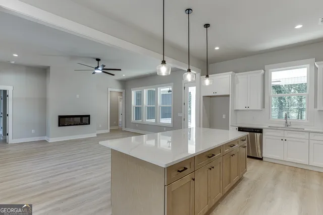 an empty room with a window and a ceiling fan