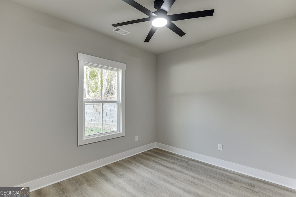 115 Rains Road Jefferson, GA 30549 - Photo 19 of 44 an empty room with a window and a fan