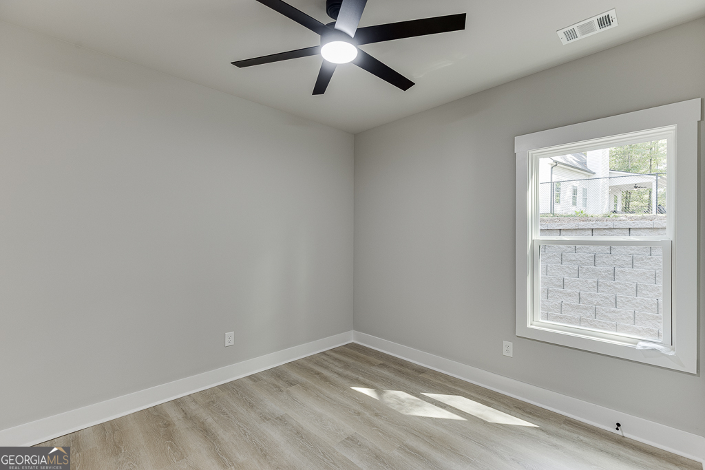 115 Rains Road Jefferson, GA 30549 - Photo 21 of 44 an empty room with a window and a ceiling fan