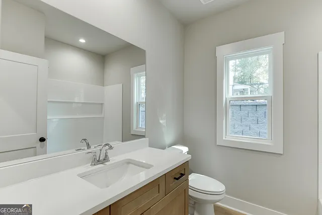 a bathroom with a double vanity sink mirror and shower