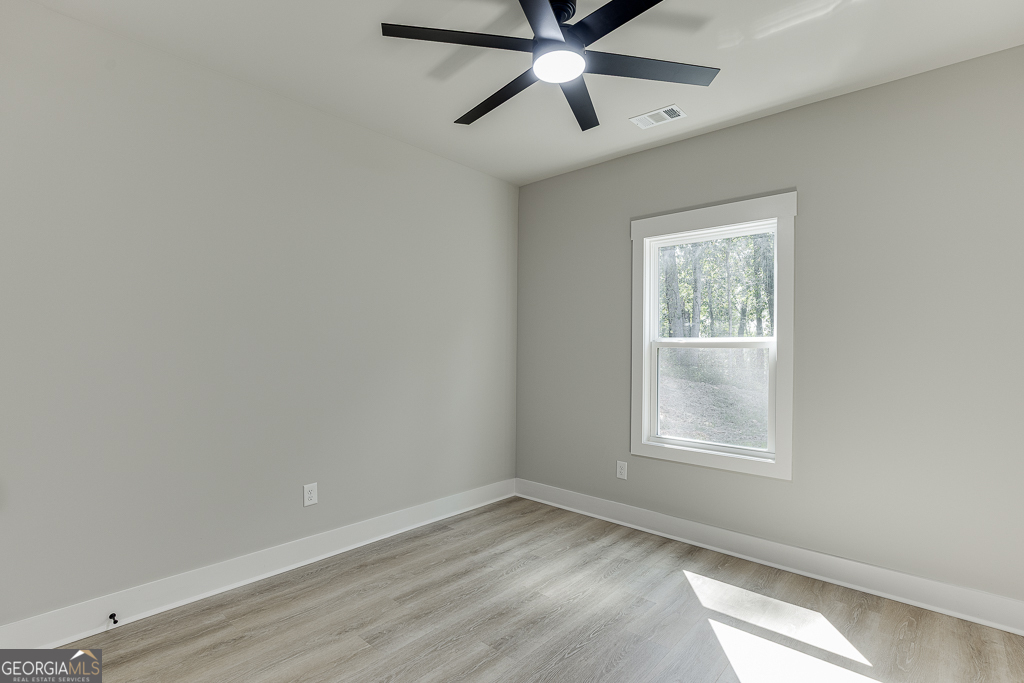 115 Rains Road Jefferson, GA 30549 - Photo 24 of 44 an empty room with a window and a fan
