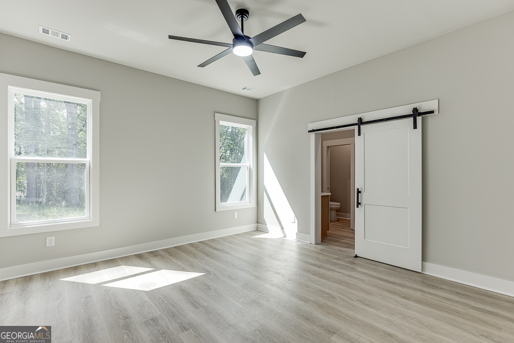 115 Rains Road Jefferson, GA 30549 - Photo 27 of 44 a view of an empty room with a window and wooden floor