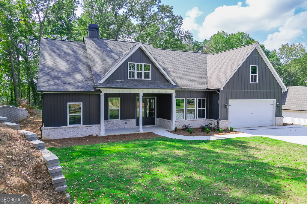 115 Rains Road Jefferson, GA 30549 - Photo 3 of 44 a front view of a house with a garden and patio