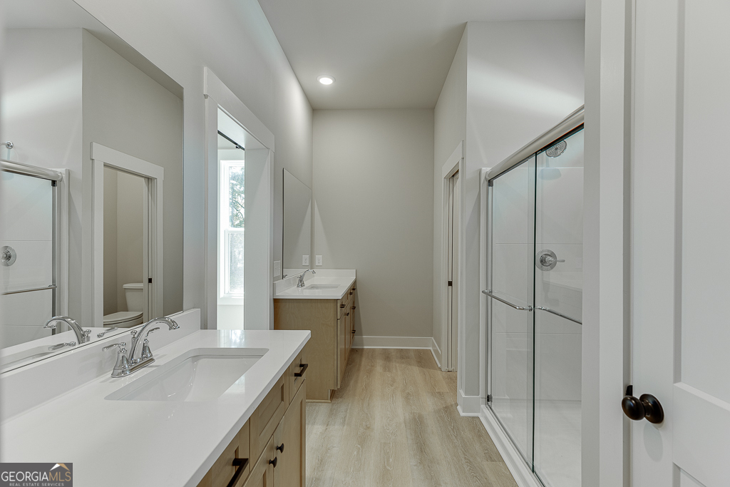 115 Rains Road Jefferson, GA 30549 - Photo 32 of 44 a bathroom with a double vanity sink mirror and shower