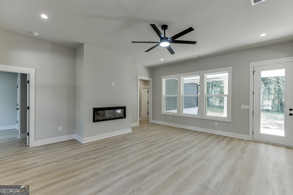 115 Rains Road Jefferson, GA 30549 - Photo 5 of 44 a view of empty room with wooden floor and window