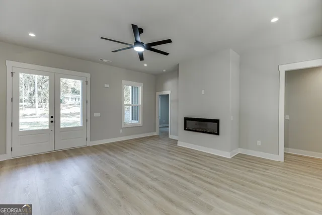a large kitchen with kitchen island a stove a sink a counter space and wooden floor