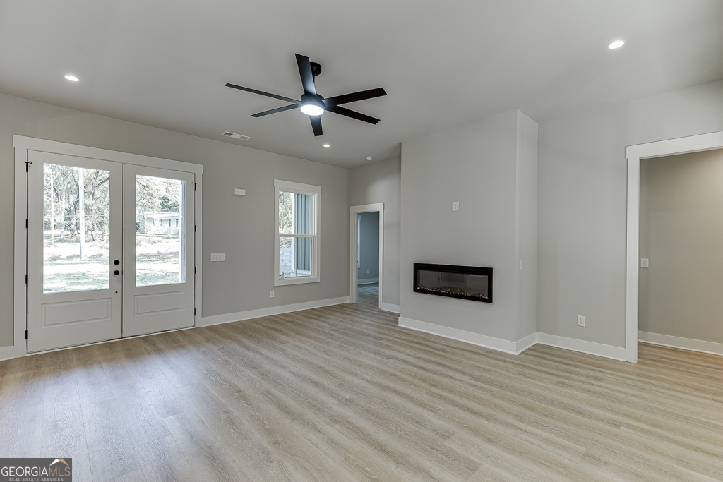 115 Rains Road Jefferson, GA 30549 - Photo 7 of 44 a view of an empty room with wooden floor and a window