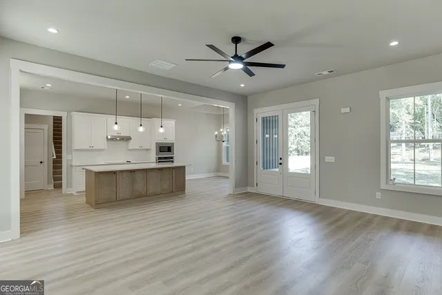 a kitchen with stainless steel appliances granite countertop a sink a oven and a wooden floors