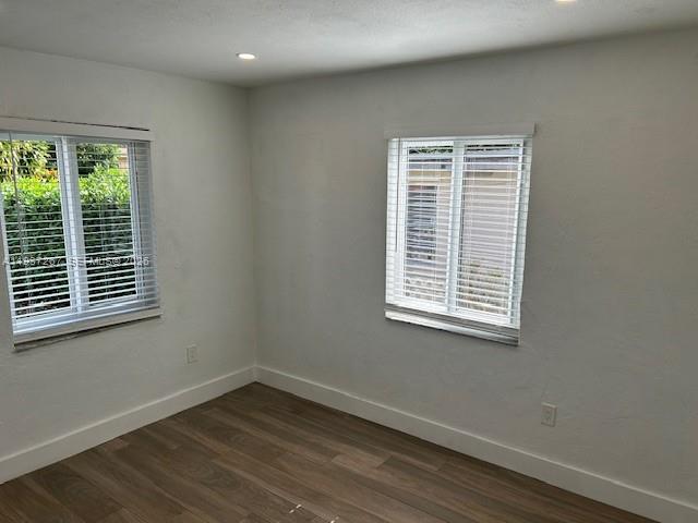 231 Southwest 51st Place Miami, FL 33134 - Photo 11 of 26 a view of an empty room with wooden floor and a window