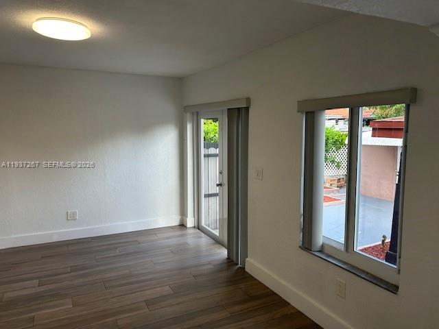 231 Southwest 51st Place Miami, FL 33134 - Photo 16 of 26 an empty room with wooden floor and windows