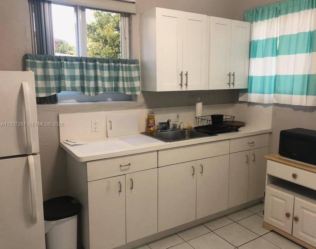 231 Southwest 51st Place Miami, FL 33134 - Photo 24 of 26 a kitchen with a sink and cabinets