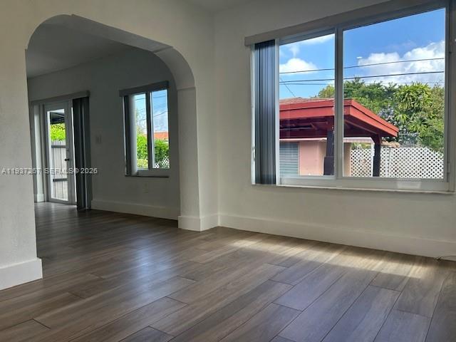 231 Southwest 51st Place Miami, FL 33134 - Photo 6 of 26 an empty room with wooden floor and windows