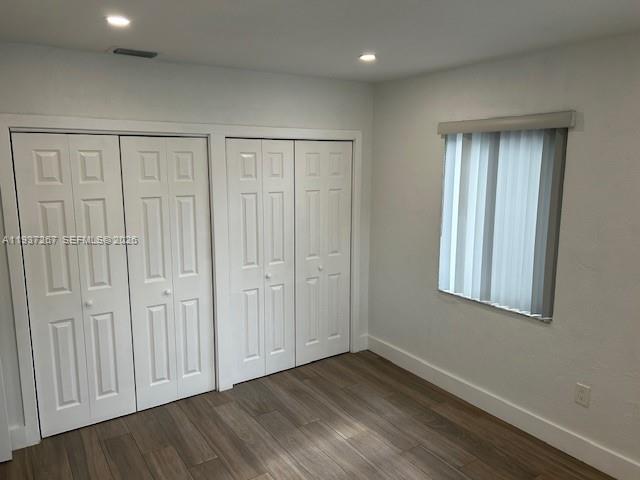 231 Southwest 51st Place Miami, FL 33134 - Photo 8 of 26 an empty room with wooden floor and windows