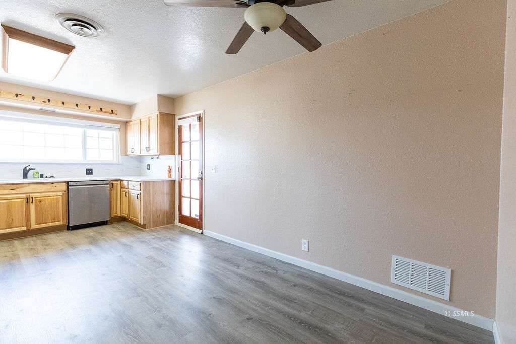 220 South American Street Ridgecrest, CA 93555 - Photo 8 of 25 a view of a kitchen with a sink cabinets and wooden floor