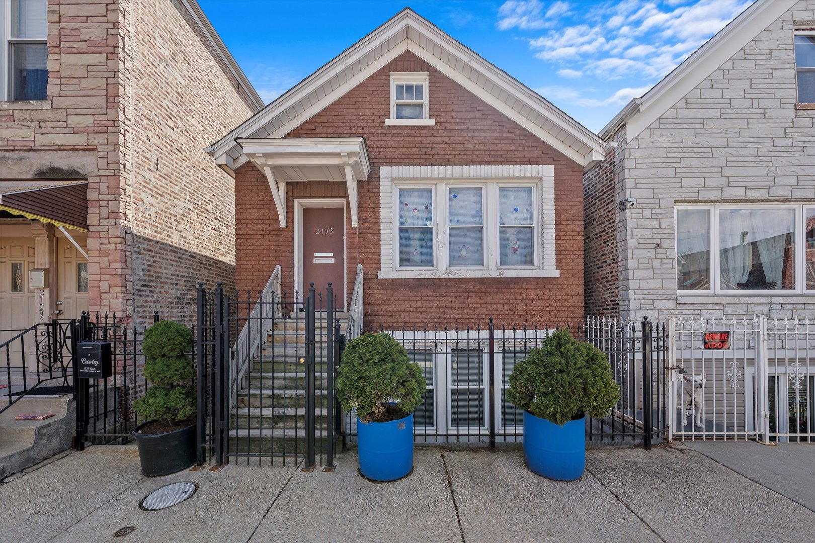 a front view of a house with potted plants