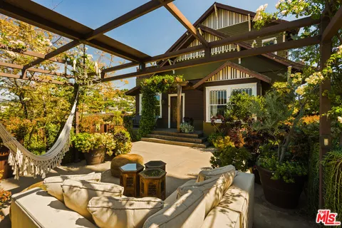 a view of a patio with table and chairs and potted plants