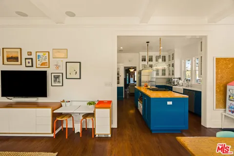 a bed sitting in a spacious bedroom next to a window