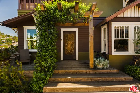 a front view of a house with plants