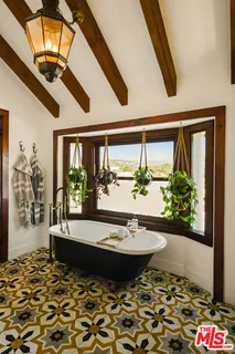 a view of a patio with couches and potted plants