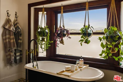 a view of a patio with couches table and chairs and potted plants