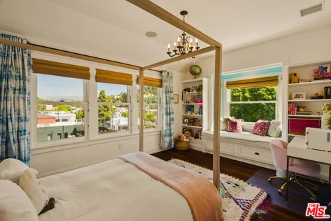 a reading room with furniture pool table and a window
