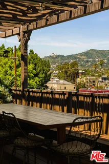 a front view of a house with a yard and outdoor seating