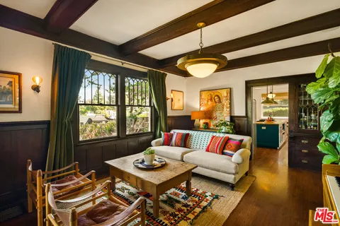 a kitchen with stainless steel appliances a sink a stove and a wooden floor