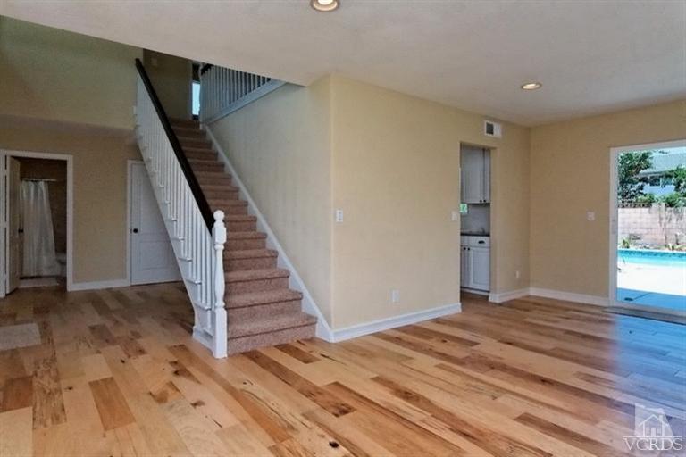 1391 Lowery Street Simi Valley, CA 93065 - Photo 2 of 16 a view of a livingroom with wooden floor and stairs