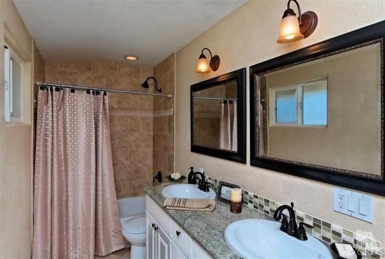 1391 Lowery Street Simi Valley, CA 93065 - Photo 12 of 16 a bathroom with double vanity and a mirror