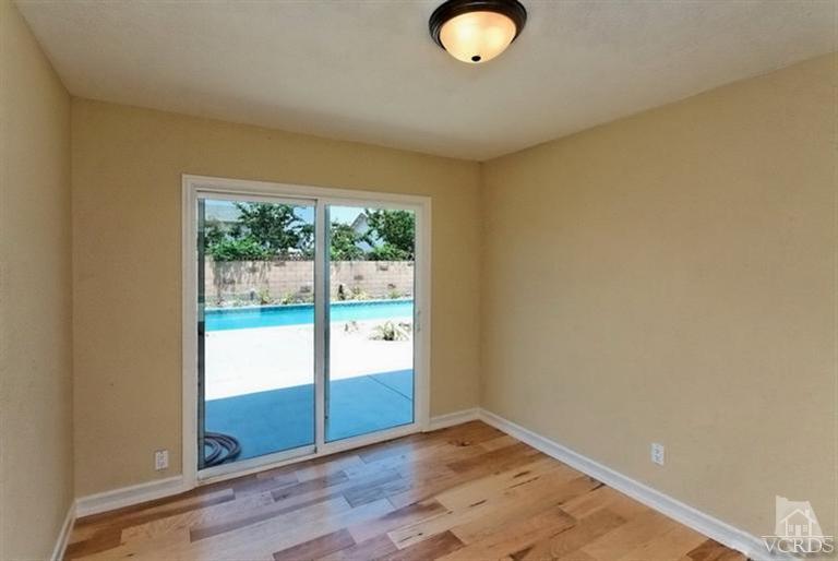 1391 Lowery Street Simi Valley, CA 93065 - Photo 15 of 16 an empty room with wooden floor and windows