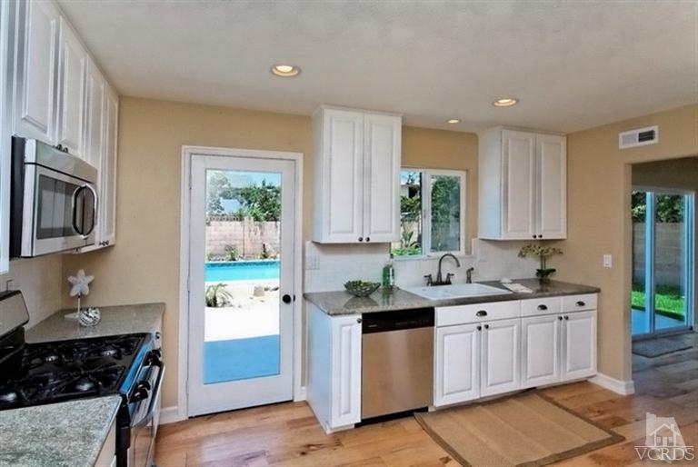 1391 Lowery Street Simi Valley, CA 93065 - Photo 7 of 16 a kitchen with a sink stove top oven and cabinets