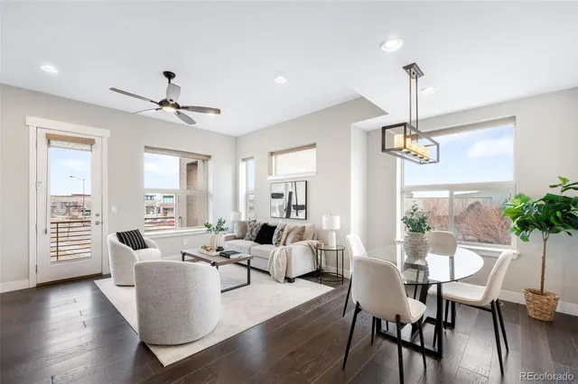 a living room with furniture wooden floor and a chandelier