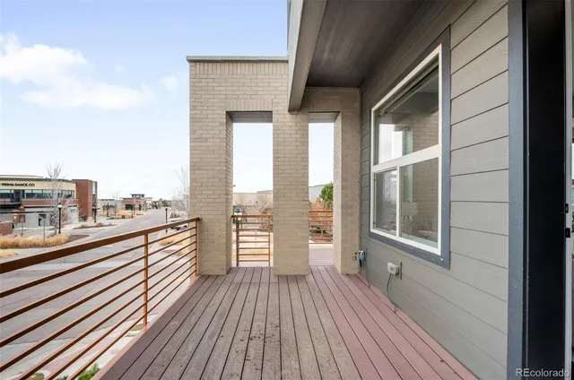 a view of a balcony with floor to ceiling windows with wooden floor