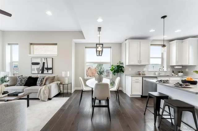 a living room with furniture and kitchen view