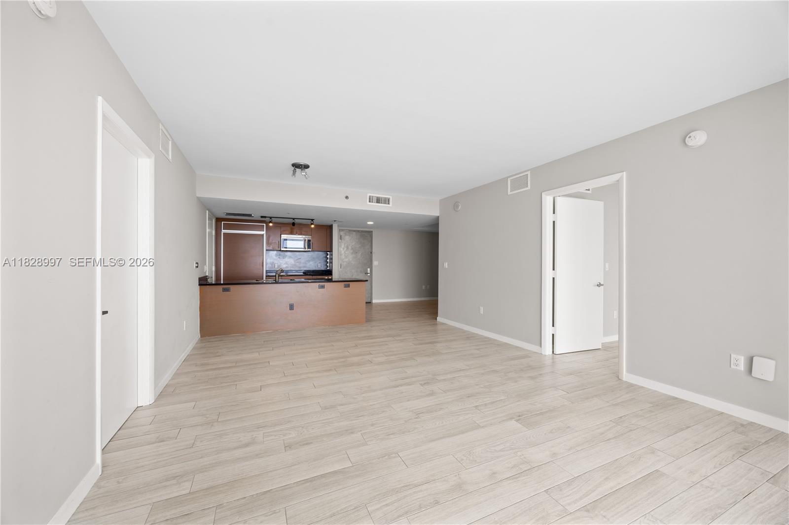 50 Biscayne Boulevard, Unit 4706 Miami, FL 33132 - Photo 11 of 49 a big room with wooden floor and windows