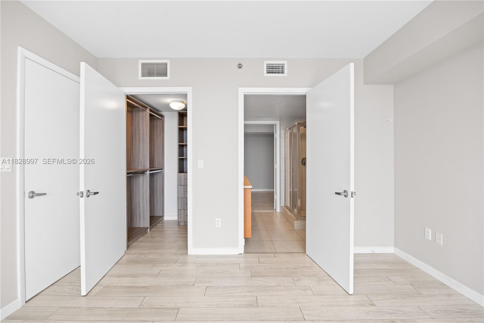 50 Biscayne Boulevard, Unit 4706 Miami, FL 33132 - Photo 24 of 49 a view of a hallway with wooden floor and closet