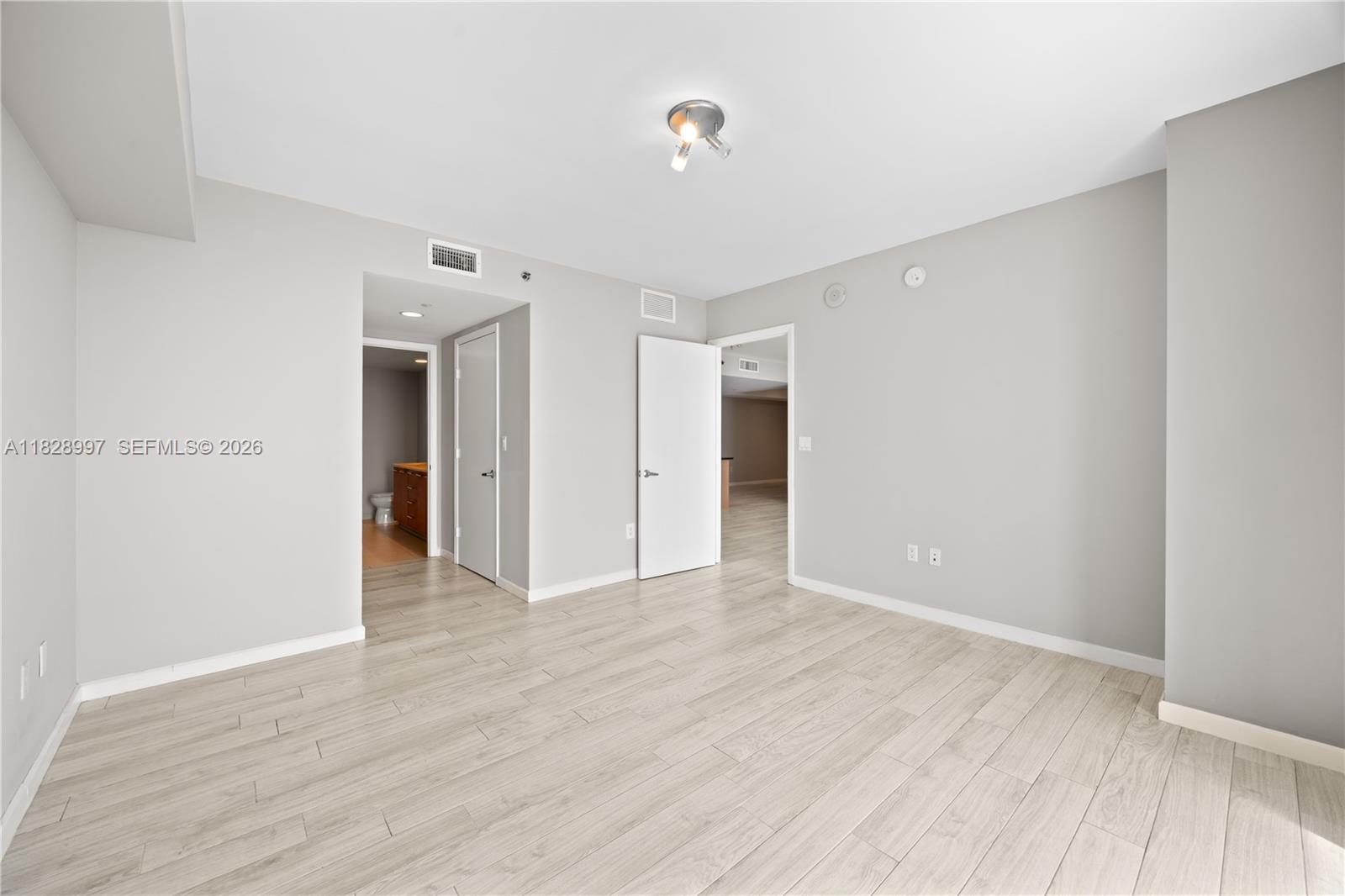 50 Biscayne Boulevard, Unit 4706 Miami, FL 33132 - Photo 27 of 49 a view of an empty room with wooden floor
