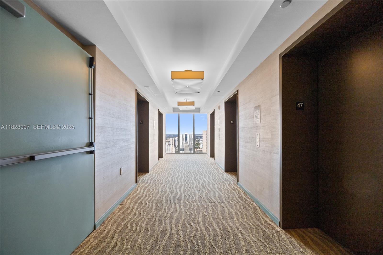 50 Biscayne Boulevard, Unit 4706 Miami, FL 33132 - Photo 34 of 49 a view of a hallway with wooden floor and a bathroom