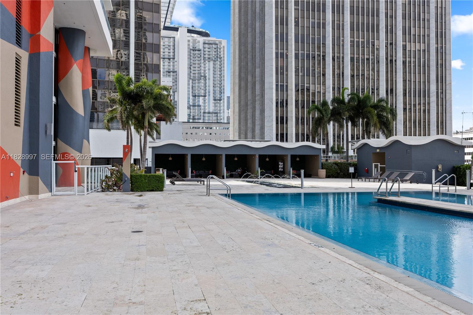 50 Biscayne Boulevard, Unit 4706 Miami, FL 33132 - Photo 37 of 49 a view of a swimming pool with chairs