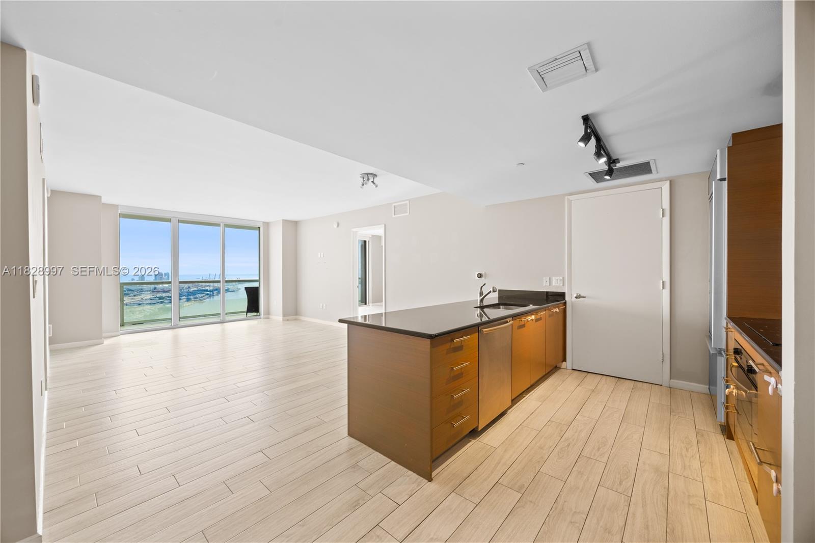 50 Biscayne Boulevard, Unit 4706 Miami, FL 33132 - Photo 4 of 49 a kitchen with stainless steel appliances granite countertop a stove and a refrigerator