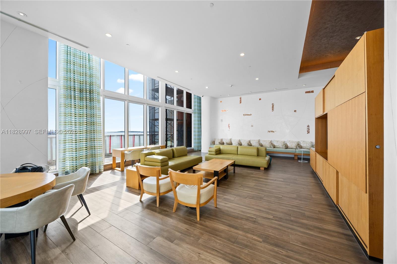 50 Biscayne Boulevard, Unit 4706 Miami, FL 33132 - Photo 41 of 49 a living room with furniture and a wooden floor