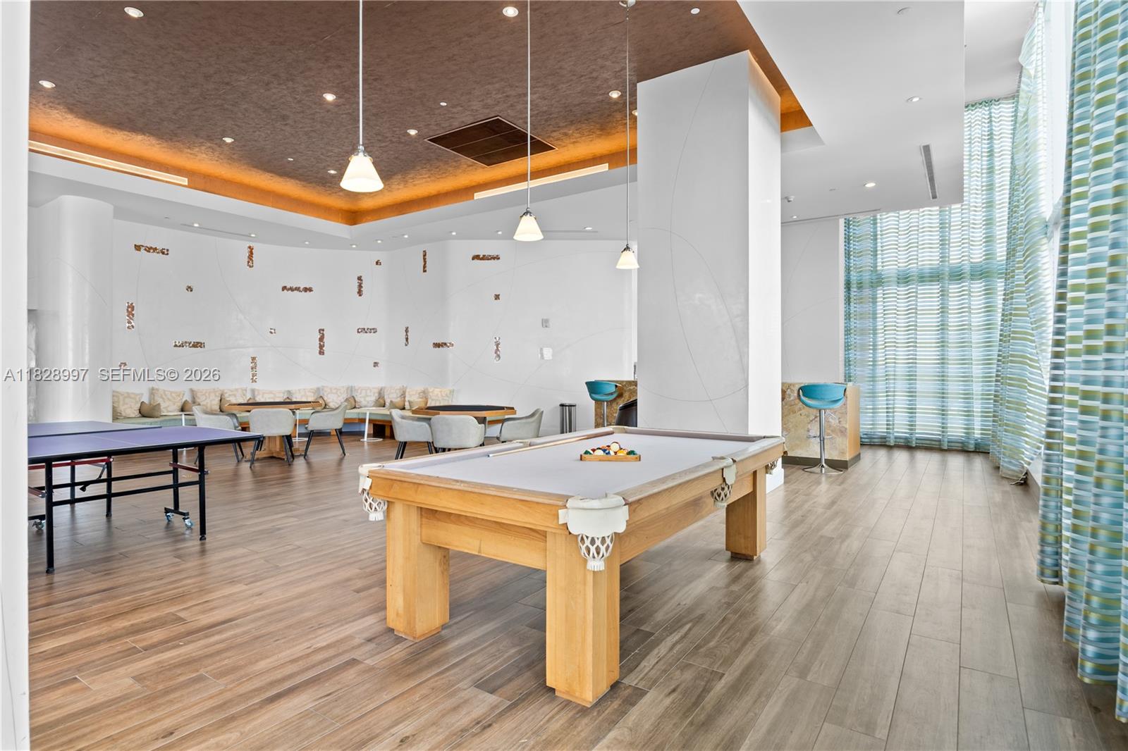 50 Biscayne Boulevard, Unit 4706 Miami, FL 33132 - Photo 43 of 49 a room with wooden floor table and chairs